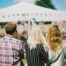 three people standing with their back turned to the camera at a summer festival advert for promo products