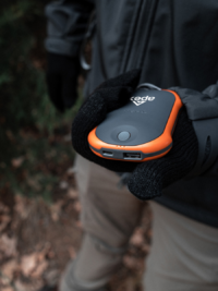 visual of a person holding onto a hand warmer/electronic charger 